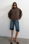 Front image of a model wearing the Freya denim jacket in brown, by brand Top shop