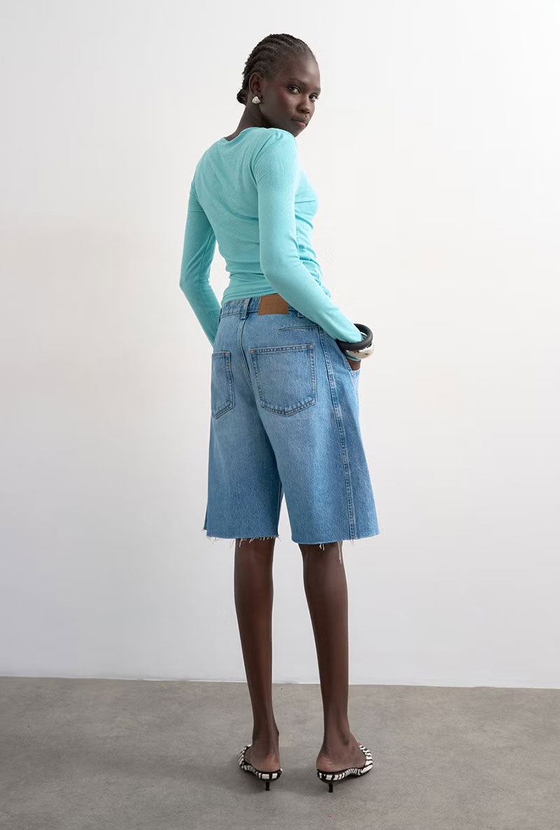 Back image of a model wearing Joa denim barrel jort in denim, by brand Top shop