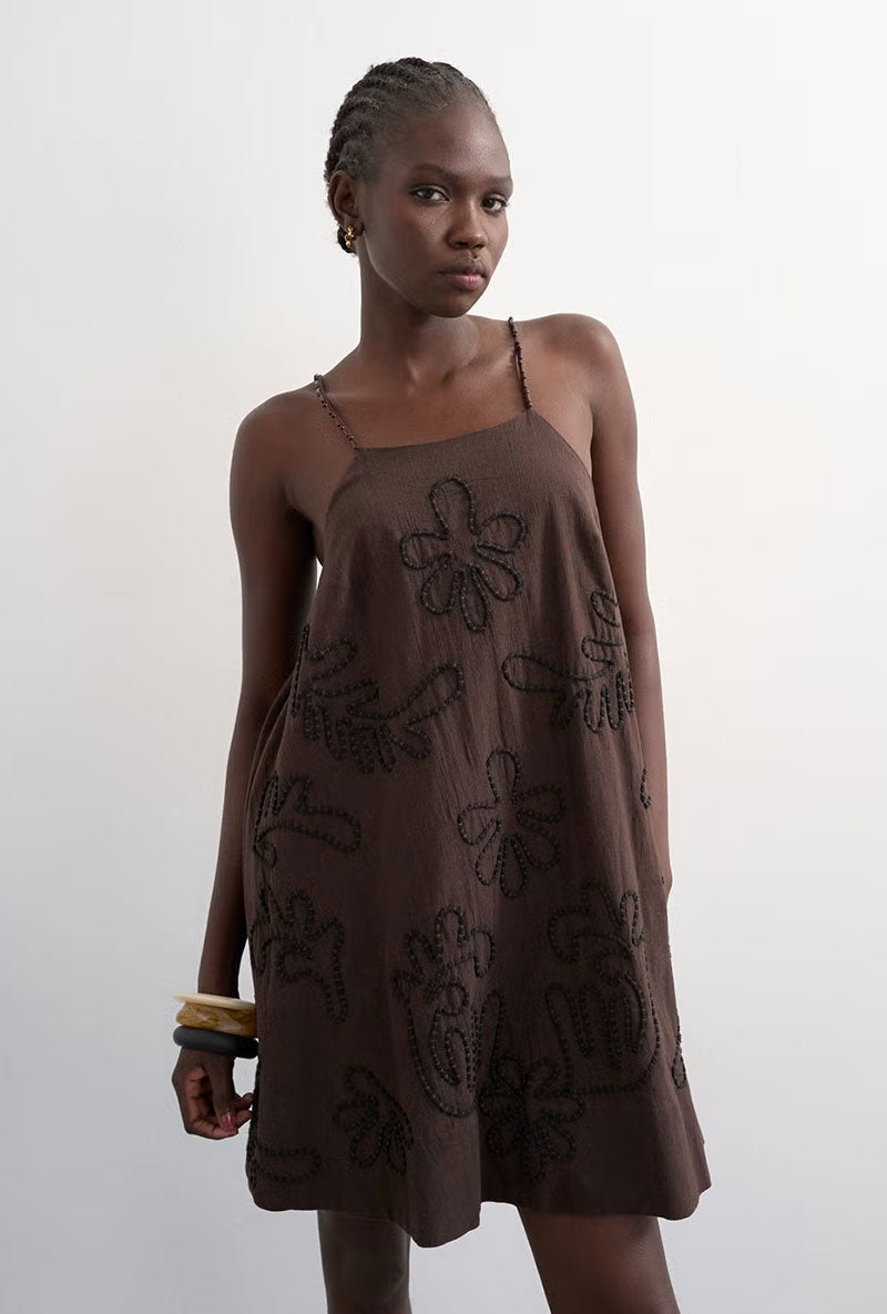 Front image of a model wearing Mia trapeze mini dress in chocolate, by brand Top shop