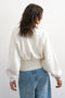 Back image of a model wearing the Rega cinch waist sweatshirt in off white, by brand Top shop