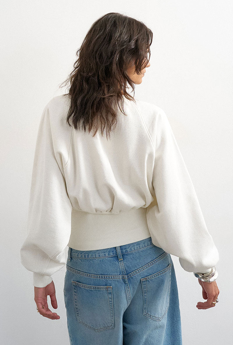 Back image of a model wearing Rega cinch waist sweatshirt in off white, by brand Top shop