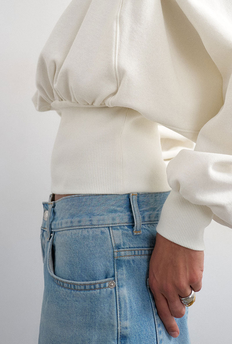 Front image of a model wearing Rega cinch waist sweatshirt in off white, by brand Top shop