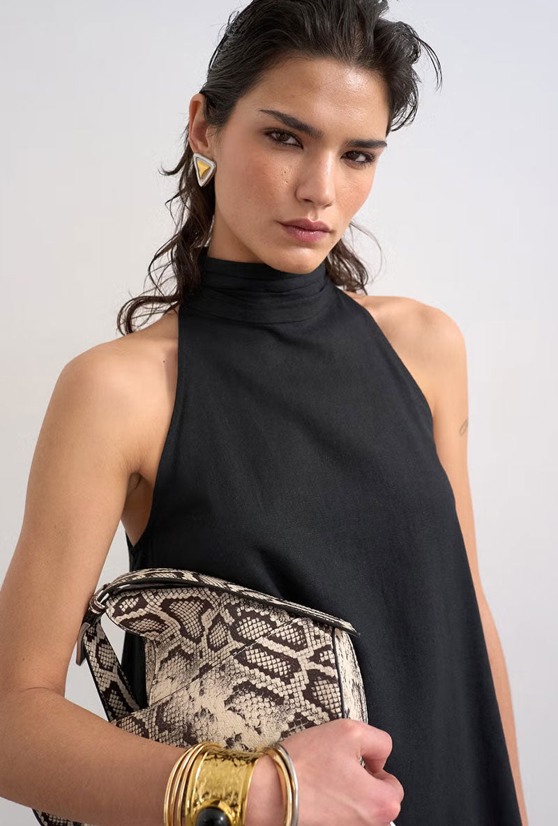 Front image of a model wearing Sara sl trapeze mini dress in black, by brand Top shop