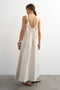 Back image of a model wearing the Selena open back maxi dress in beige, by brand Top shop