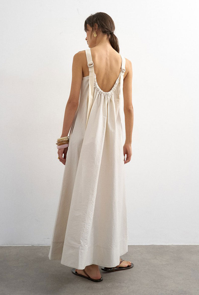 Back image of a model wearing Selena open back maxi dress in beige, by brand Top shop