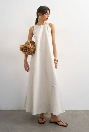 Front image of a model wearing the Selena open back maxi dress in beige, by brand Top shop