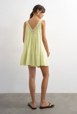 Back image of a model wearing the Sophie deep v mini dress in lime, by brand Top shop
