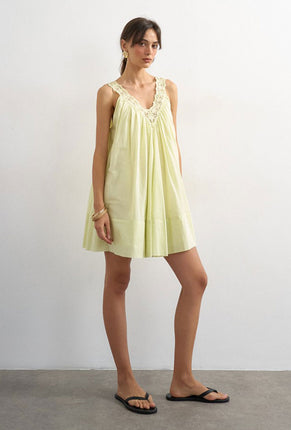 Front image of a model wearing Sophie deep v mini dress in lime, by brand Top shop