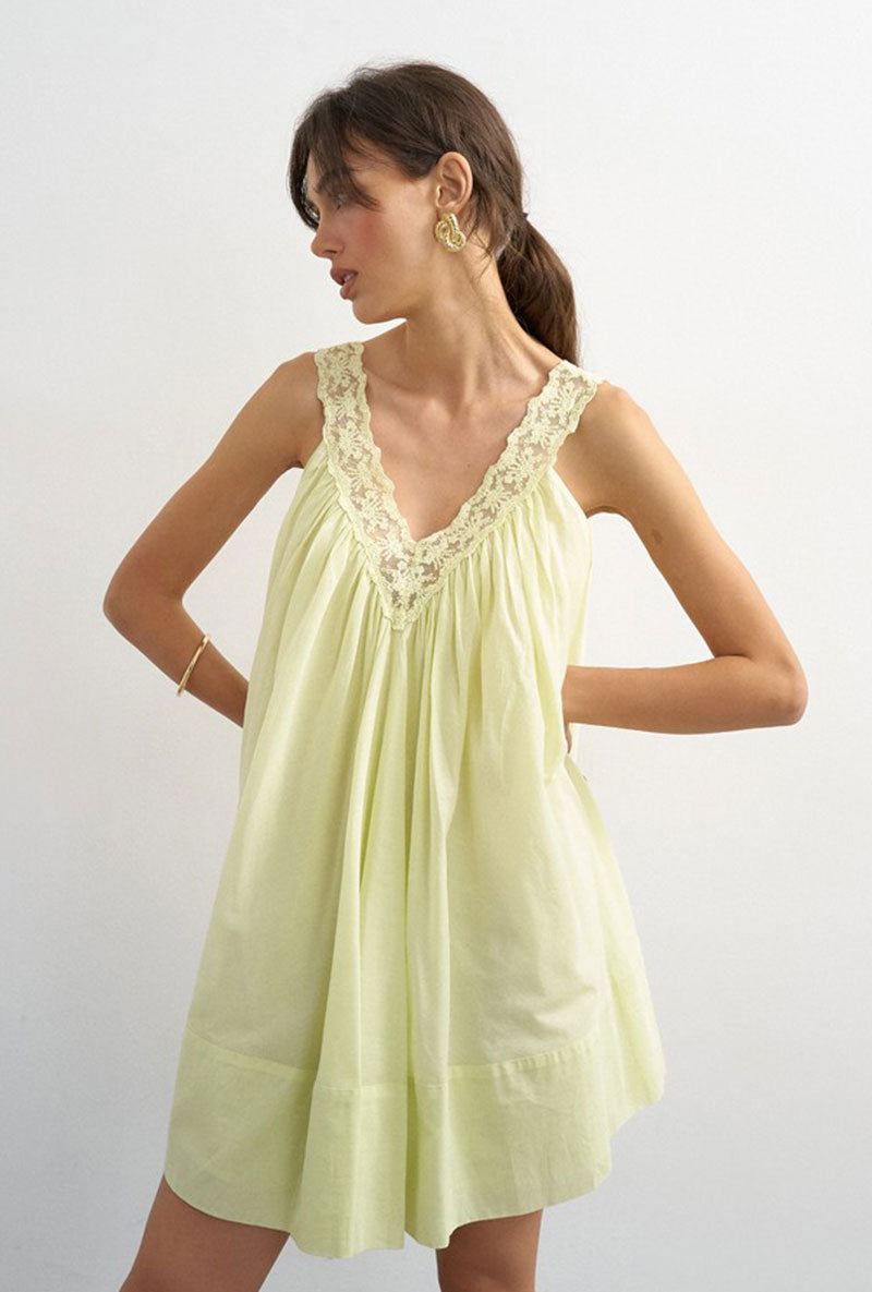 Front image of a model wearing Sophie deep v mini dress in lime, by brand Top shop