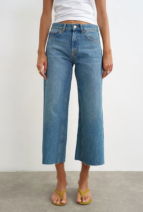 Front image of a model wearing Vera hr wide cropped jeans in denim, by brand Top shop