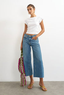 Front image of a model wearing the Vera hr wide cropped jeans in denim, by brand Top shop