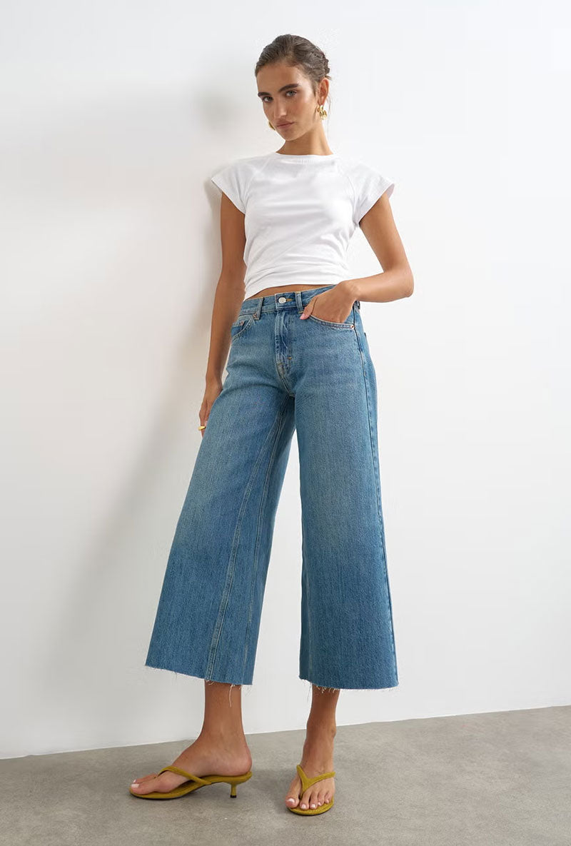 Front image of a model wearing Vera hr wide cropped jeans in denim, by brand Top shop