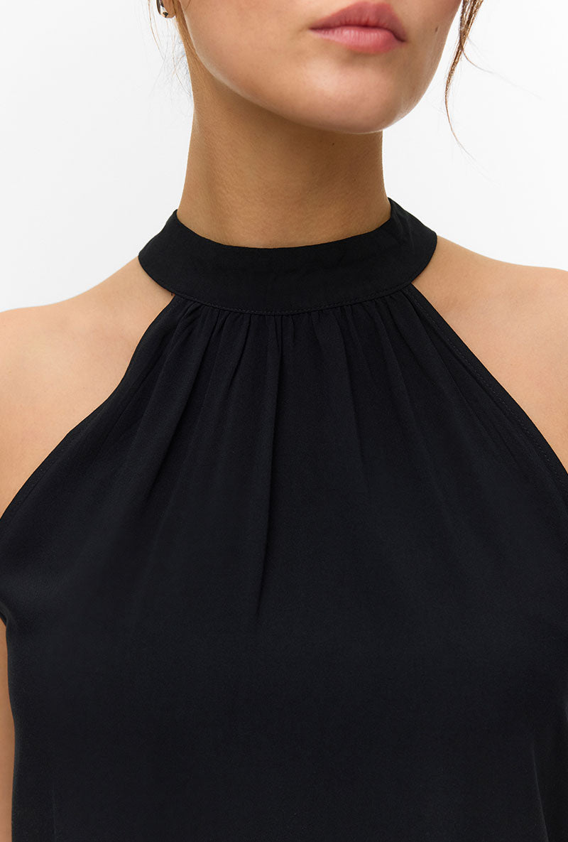 Front image of a model wearing Easy joy s/l  halterneck top in black, by brand Vero moda