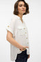 Front image of a model wearing the Bumpy ss shirt in white, by brand Vero moda