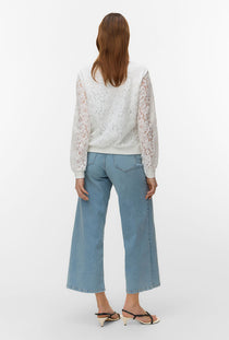 Back image of a model wearing the Honey lace bomber jacket in white, by brand Vero moda