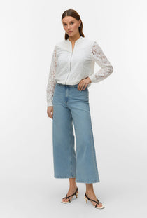 Front image of a model wearing the Honey lace bomber jacket in white, by brand Vero moda