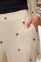 Front image of a model wearing the Kai mw pants in beige, by brand Vero moda