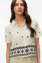 Front image of a model wearing the Kai s/s shirt in beige, by brand Vero moda