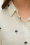Front image of a model wearing the Kai s/s shirt in beige, by brand Vero moda