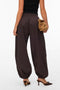 Back image of a model wearing the Lotus balloon trousers in chocolate, by brand Vero moda