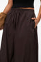 Front image of a model wearing the Lotus balloon trousers in chocolate, by brand Vero moda