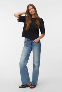 Front image of a model wearing the Lyla ss oneck top in black, by brand Vero moda
