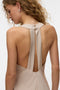 Back image of a model wearing the Reba hibisca ankle dress in beige, by brand Vero moda