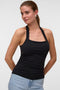 Front image of a model wearing Valerie halterneck top in black, by brand Vero moda