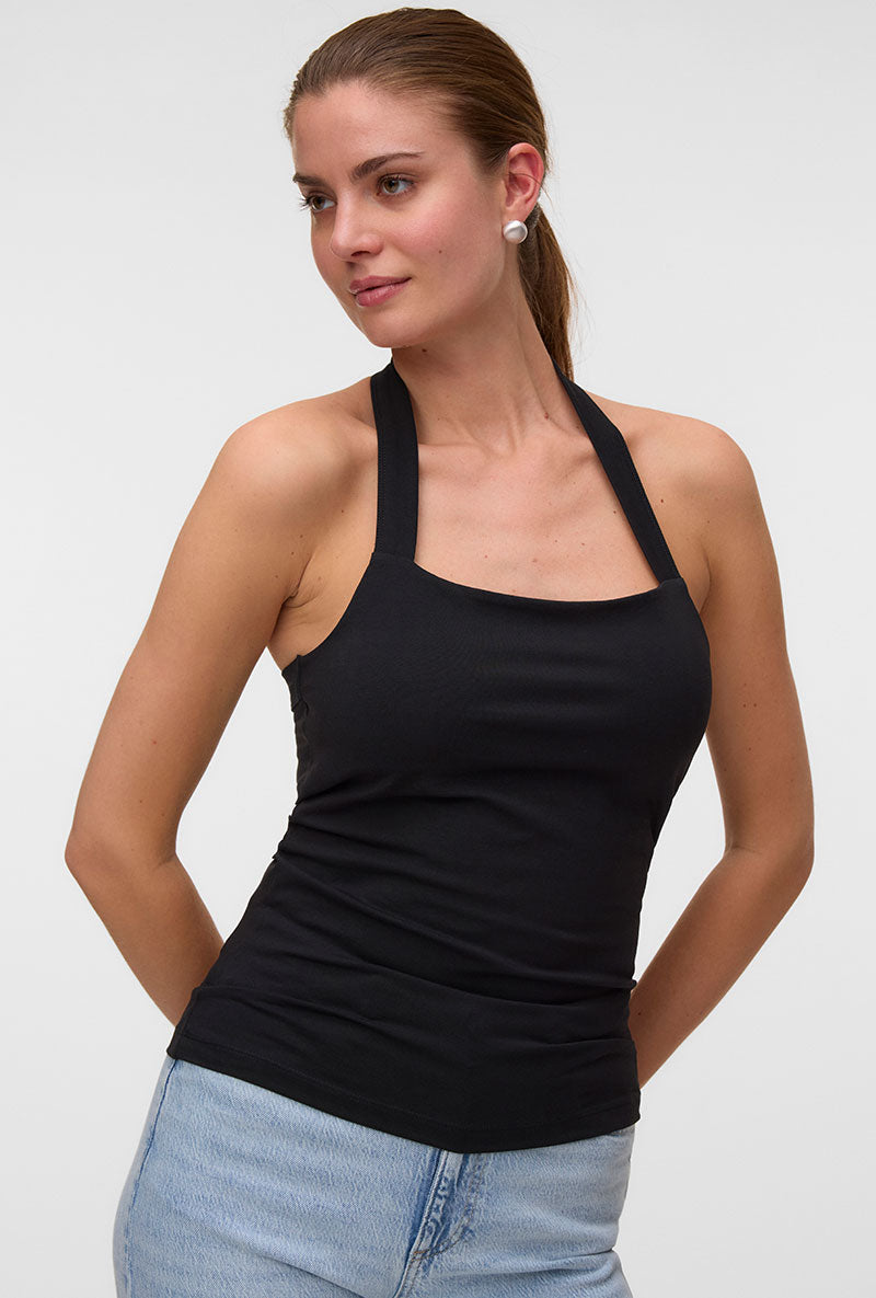 Front image of a model wearing Valerie halterneck top in black, by brand Vero moda