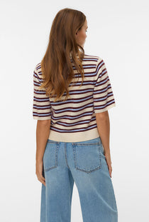 Back image of a model wearing the Canna 2/4 poloneck pullover in beige, by brand Vero moda