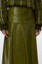 Front image of a model wearing the Dash hw coated skirt in green, by brand Vero moda