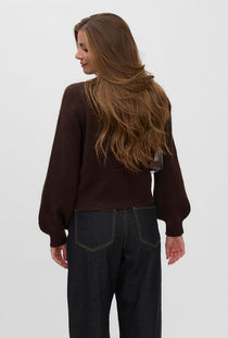 Back image of a model wearing the Hazel ls oneck cardigan in chocolate, by brand Vero moda