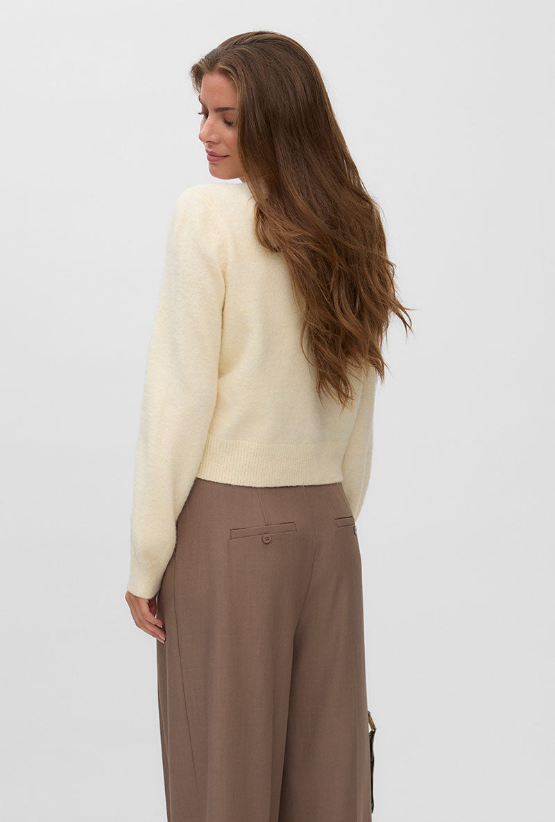 Back image of a model wearing Hazel ls oneck cardigan in cream, by brand Vero moda