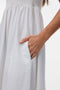 Front image of a model wearing the Lisa bandeau ankle dress in off white, by brand Vero moda