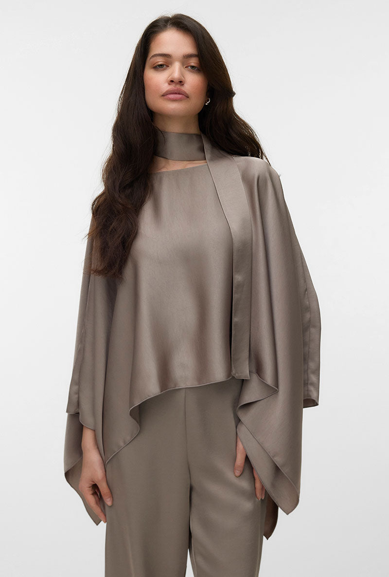 Front image of a model wearing Miro ls cape scarf top in bronze, by brand Vero moda
