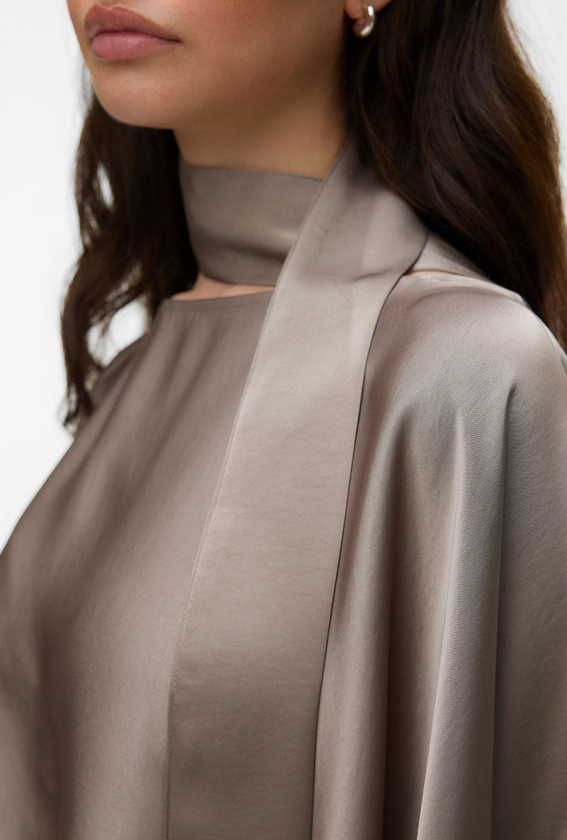 Front image of a model wearing Miro ls cape scarf top in bronze, by brand Vero moda