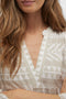 Neck detail image of a model wearing the Dicthe 3/4 tunic in stone, by brand Vero moda